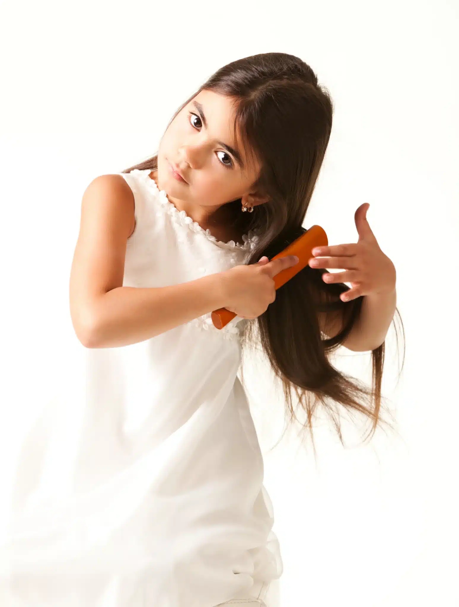 Glenmoore girl in white dress combing brown hair scaled