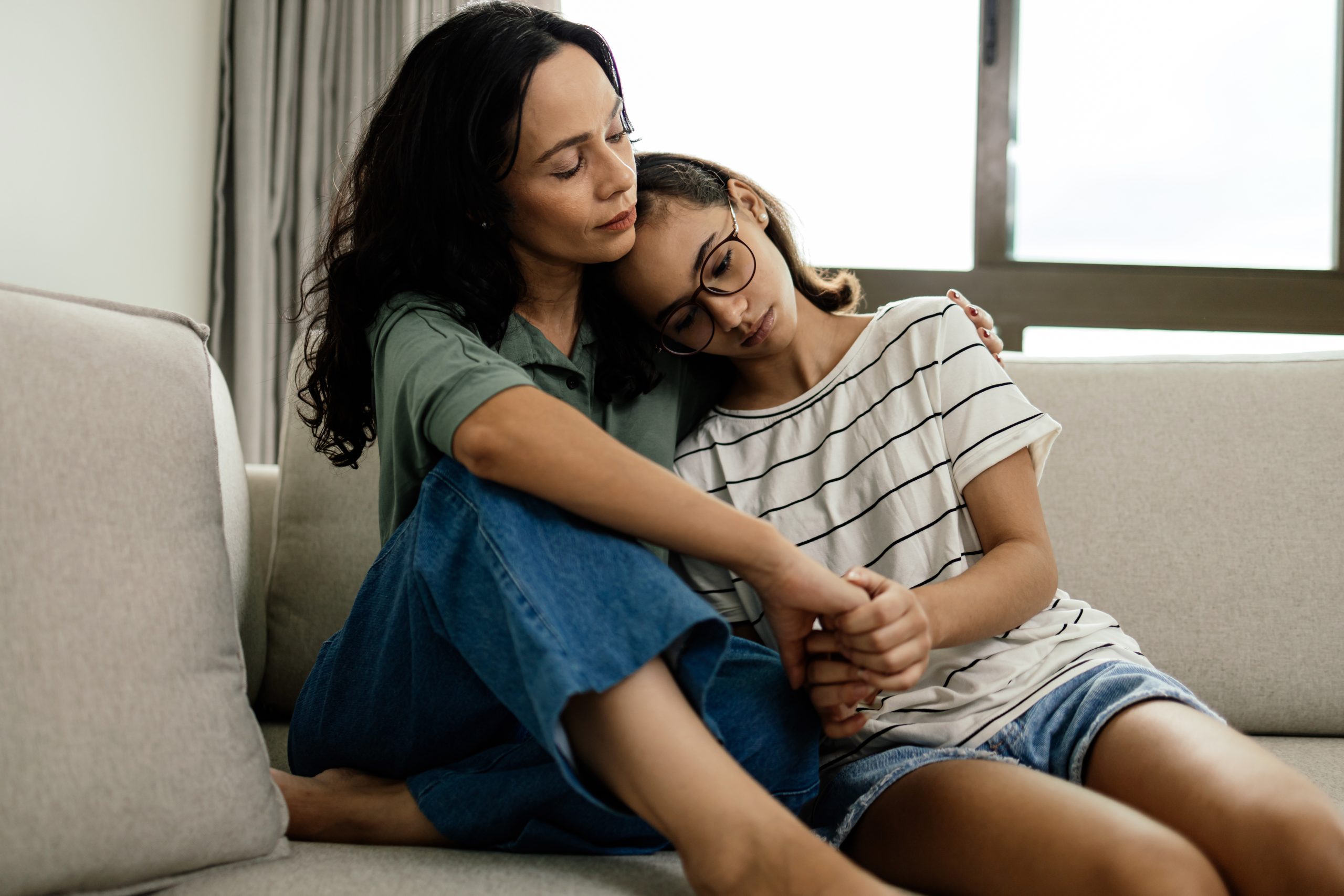 Parent comforting child for article about lice stigma and hygiene myths