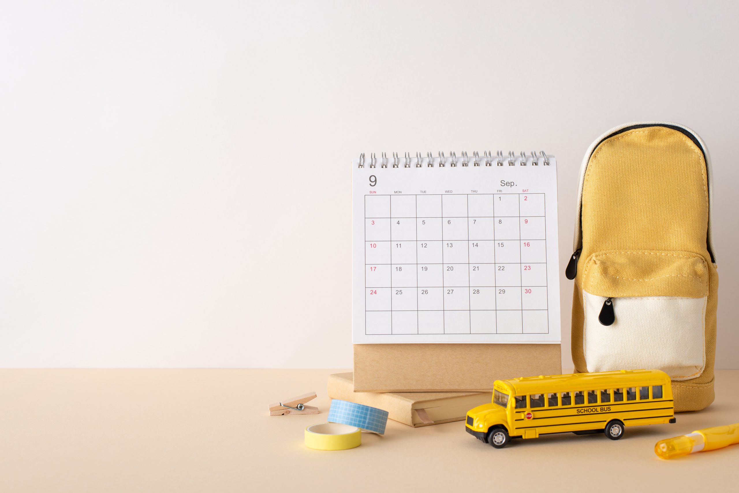 School-year calendar and backpack for article about seasonal head lice patterns