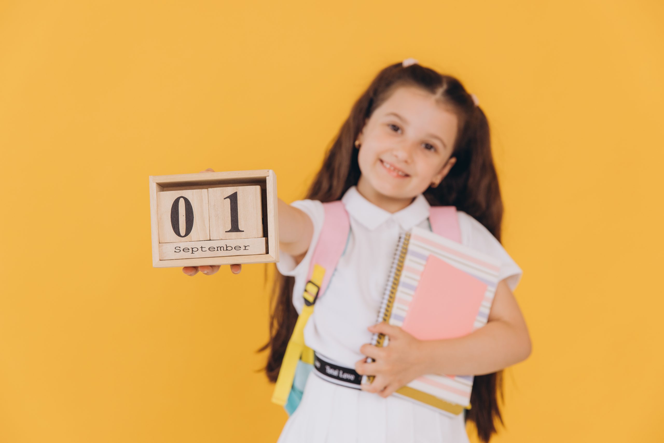 Student holding calendar for article about year-round lice season risks